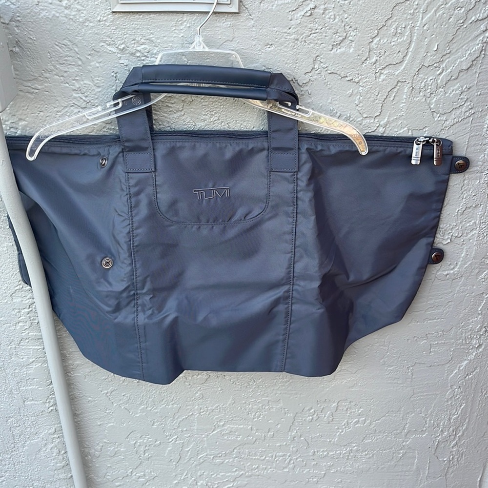 Tumi fold up gray tote has snaps to make smaller